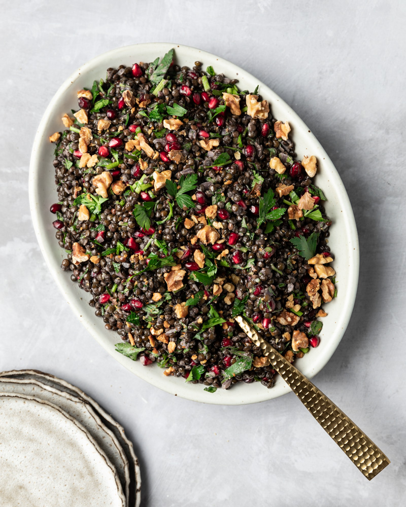 black lentil pomegranate salad on a serving platter