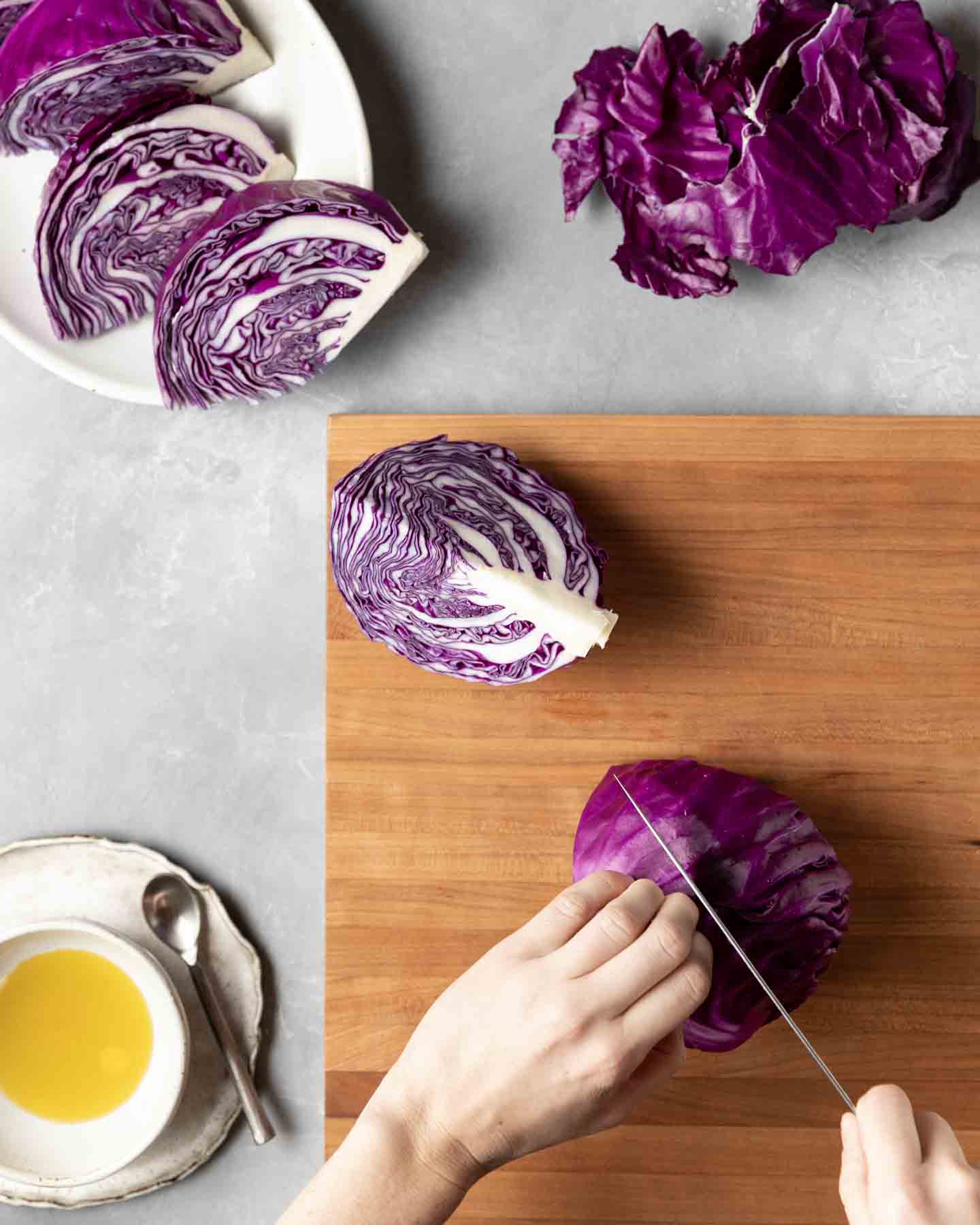 In preparation for cooking, a whole head of cabbage is cut into 8 equal wedges.