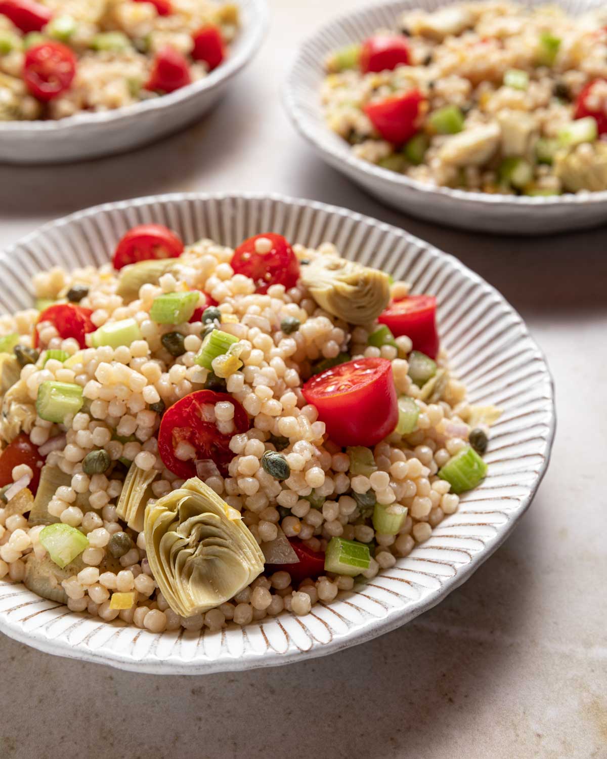 Moroccan Couscous Salad served in several white bowls