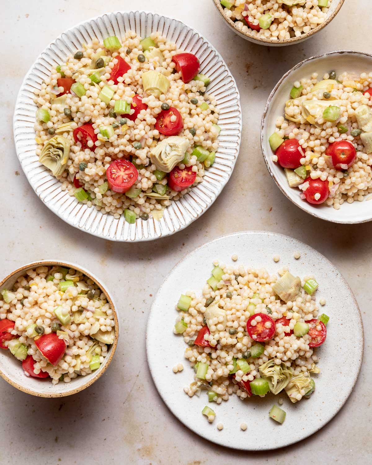 An overhead view of the finished salad served on multiple plates and bowls