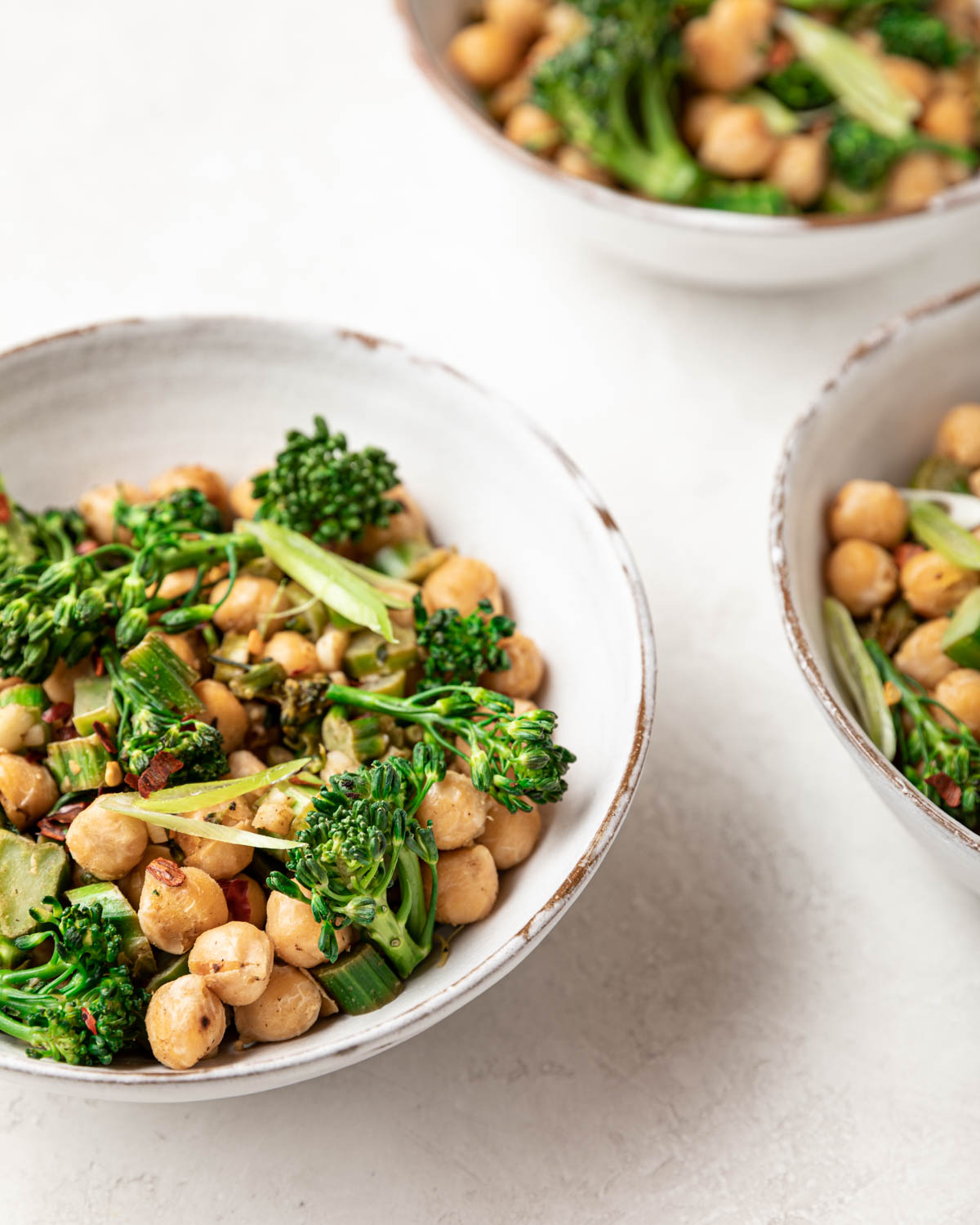 A closeup view of the prepared meal showing bright green broccolini and crispy garbanzo beans